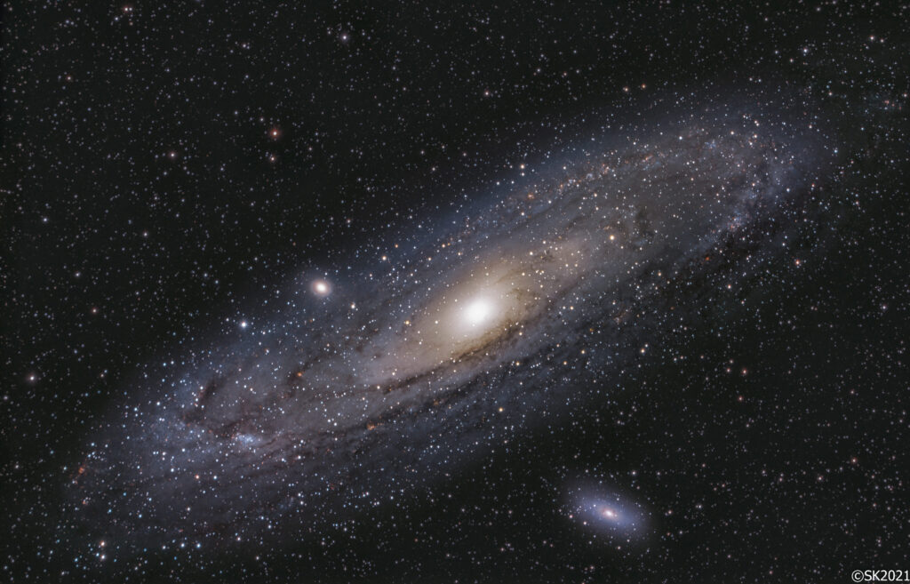 The Andromeda Galaxy M31 with dust lanes and the companion galaxies M32 and M110, photographed with a long exposure