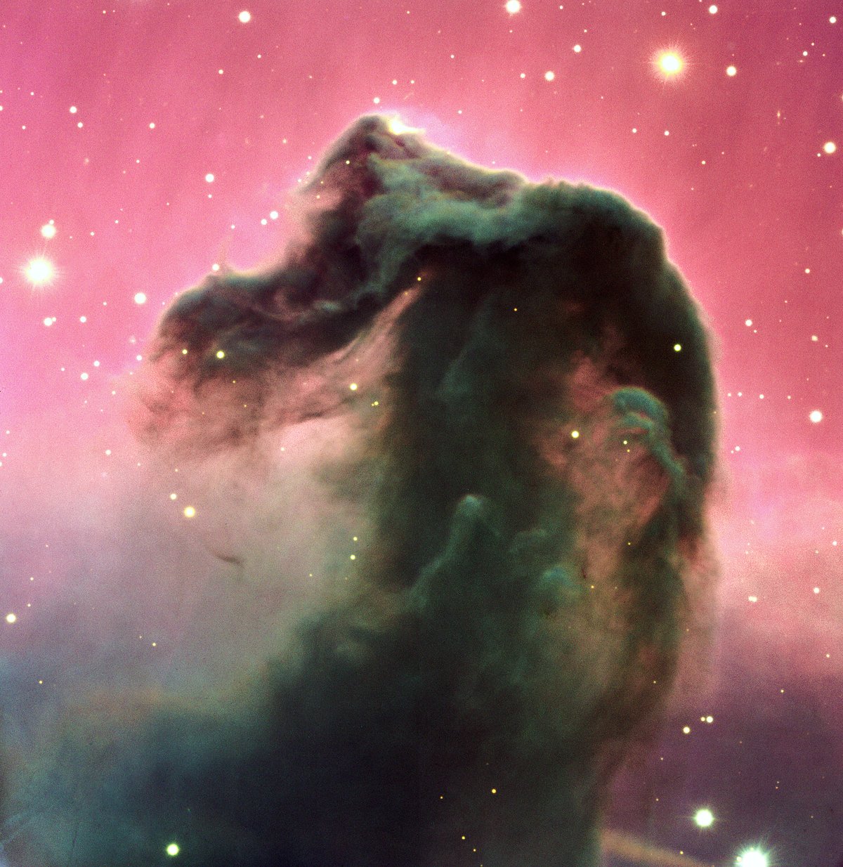 The Horsehead Nebula Barnard 33 as a dark silhouette against red-glowing gas